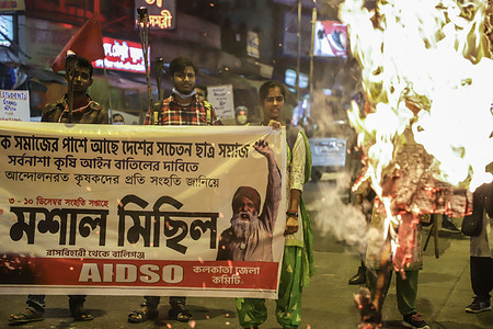 Protesters holding a banner seen next to a burning effigy of India's prime minister, Narendra Modi during the demonstration.Activists of AIDSO (All India Democratic Students' Organization) farmers' movement in Delhi protest against the government imposed farm bill (3 agricultural bill passed by the parliament of India on 27th September 2020).
