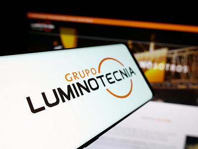 In this photo illustration, a smartphone with the logo of Paraguayan company Grupo Luminotecnia is seen on screen in front of website.