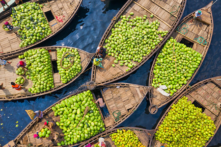 (EDITORS NOTE: Image taken with a drone)
Boats seen carrying piles of water melon fruit at the wholesale fruit market.
Thousands of watermelons are piled on boats at a bustling water market ready to be sold. Workers carrying large baskets of the fruit off the dozens of wooden boats before they are loaded onto delivery vans at the busy water market at Sadarghat in Dhaka, Bangladesh. Everyday more than 100.000 watermelons come from different district to this wholesale fruit market, said local fruit wholesalers.