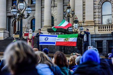 Pro-Jewish Iranians with flags showing their support during the Pro-Jewish Rally organised by the Christian led "Never Again Is Now" movement to stand against hate and antisemitism and to support Jewish community.