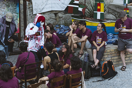 Laika MCMLIV (C) is seen among the camping participants. The street artist and activist Laika inaugurated a new murals dedicated to migrants created during the camping promoted by the Spostiamo Mari e Monti association.