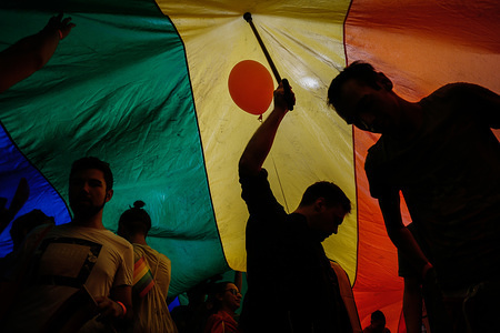 Participants are seen holding a large LGBT flag while walking through the street during the yearly Belgrade Gay Pride. Gay Pride in Serbia has been held since 2001, and this event is the fourth in a row that goes without problems as a large recent Serbian politicians including the prime minister Ana Brnabić and mayor of Belgrade Siniša Mali. started to support the Gay parade and the LGBT community.