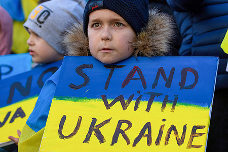 Young boy holds up a placard expressing his opinion, during the demonstration.Thousands show up in Manchester Piccadilly Gardens to show support and solidarity for those suffering in Ukraine. Schoolchildren held up banners and had their faces painted while others spoke on the steps of the Queen Victoria Statue.