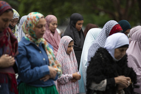 A Muslim young girl prays during Eid al-Fitr prayers marking the end of Ramadan at Flagstaff Gardens in Melbourne. Hundreds gathered at Flagstaff Garden in Melbourne to observe Eid al-Fitr prayers, marking the end of Ramadan and celebrating Eid al-Fitr, as the Muslim community came together for a significant moment of worship, reflection, and unity.
