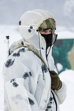 The sniper peers into the snowy haze of the polygon during a sniper training class.Russian Guard special forces snipers train at a closed training center.