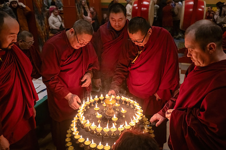 Buddhist monks light candles during the celebration of the Buddhist festival Zula. Worshippers gathered to commemorate the Buddhist festival of Zula, also known as Galdan Namchot or the "Festival of a Thousand Lamps," at Datsan Gunzechoinei in St. Petersburg, Russia. This festival honors the birth, parinirvana (death), and enlightenment of Je Tsongkhapa, a renowned scholar and teacher of Tibetan Buddhism whose contributions led to the establishment of the Gelug school of Tibetan Buddhism.