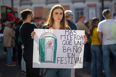 A protester holds a placard expressing her opinion during the demonstration. During the "No Kings" demonstration, protesting against US President Donald Trump and his administration at Puerta del Sol in Madrid.