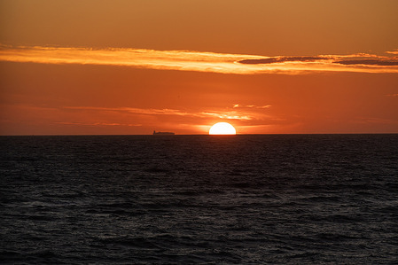 A view of a red-tinted sky over the North Sea during sunset. Nr. Lyngby is situated between Løkken and Lønstrup at the Danish west coast it is a small village and holiday area.