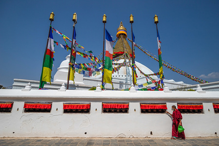 A Buddhist monk wearing a face mask as a preventive measure, walking around a deserted Boudhnath Stupa, UNESCO world heritage site during the the third day of a nationwide lock down.Nepal government decided to lock down the whole country as a preventive measure against corona virus (COVID-19) from 24 March till 31 March following a second confirmed COVID-19 case.