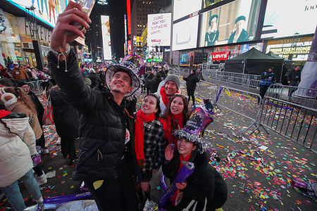 People selfie at Times Square after the ball drop. The 2024 Times Square New Year's Eve celebration in New York City mark a monumental return following the COVID-19 pandemic, drawing thousands of enthusiastic individuals to partake in the iconic countdown and welcome the new year. As tradition dictates, the dazzling ball drop captivates the crowds, signaling the transition to 2024. With the turn of the year, a breathtaking cascade of confetti descends from the skies, transforming the bustling cityscape into a mesmerizing shower of colorful paper.