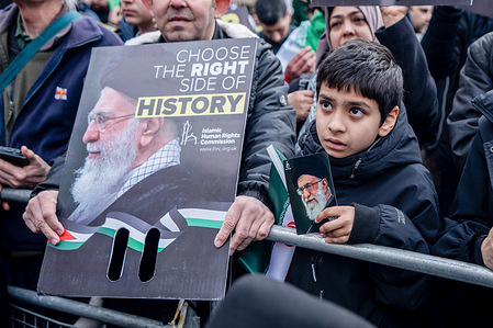 A pro-Iranian regime British-Iranian boy holds aloft a poster of the Ayatollah Ali Khamenei who was killed in the joint US-Israeli attack. Many thousands congregated in Central London in an international demonstration of support for Palestinian rights. They were separated by Police from pro-Israeli and anti-Iranian-regime counter-protestors who met on the opposite side of the River Thames after the rally was banned from marching by the Home Secretary Shabana Mahmood. Rapper Bob Vylan spoke at the rally and is currently being investigated for chanting “Death to the IDF”.
