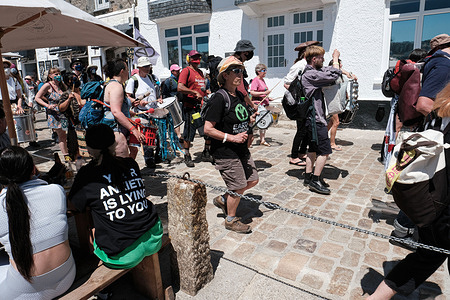 A samba band plays along the seafront in St Ives during the 'All Hands On Deck' day of action on the final day of the G7 summit in Cornwall. The theme is a reference to the Extinction Rebellion's third demand for a Citizens' Assembly on ecological and climate justice to move beyond broken parliamentary democracy and place power in the hands of citizens.