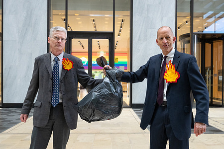 Activists seen holding a rubbish bag containing an earth shaped pinata. Activists from Fossil Free London stage an Earth Day protest outside the Shell Centre on Belvedere Road, where a campaigner dressed as an oil executive smashes an earth shaped pinata filled with blood (red liquid) using a bat labelled “Rosebank.” The stunt highlights opposition to the Rosebank oil field, the UK’s largest undeveloped oil field, and criticises Shell’s involvement and its partnership with Equinor under the Adura venture, which campaigners claim could allow the company to avoid significant UK tax contributions.
