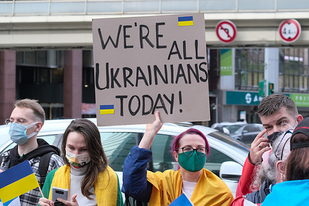 A protester holds a placard expressing her opinion, during a demonstration against Russia's military invasion on Ukraine.