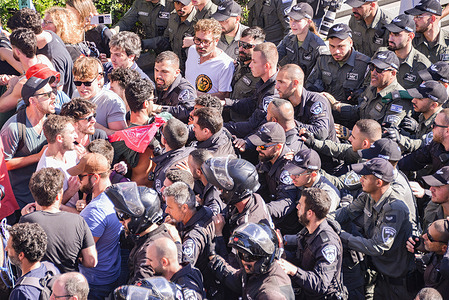 Israeli policemen push back protestors on the blocked Ayalon highway. Tens of thousands of protesters marched in Tel Aviv as a "day of resistance" against the government’s judicial overhaul plans. They blocked the Tel Aviv Ayalon Highway, to stop the traffic to critical industrial and high-tech areas throughout the capital.