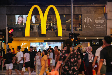 People walk past the McDonald's fast food restaurant at Bukit Bintang.