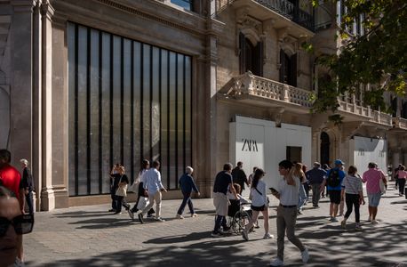 The large display window and the two entrances to the Zara store on Barcelona's Passeig de Gràcia have been reinforced with metal and wooden panels to prevent damage during the repeated anti-eviction protests.
