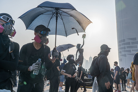 Protesters with gas masks during the demonstration.
Hong Kong pro-democracy protesters demonstrated against police brutality in Tsim Sha Tsui. The rally turned into a conflict at night in Mong Kok.