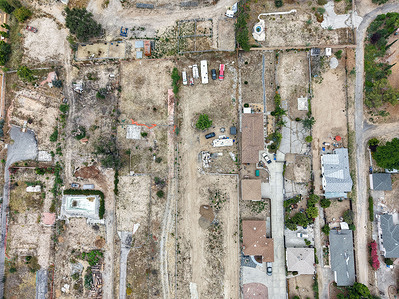 (EDITORS NOTE: Image taken with drone) 
An aerial view shows homes being rebuilt among cleared lots where residences were destroyed by the Eaton Fire in Altadena, California. The fire, which ignited on January 7, 2025, killed 19 people and destroyed more than 9,000 structures, most of them homes.