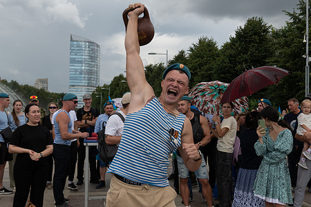 A man in a blue Russian Airborne Forces beret lifts a heavy kettlebell during the celebration of Airborne Forces Day. The 94th anniversary of the formation of the Airborne Forces is being celebrated, which is traditionally observed in Russia on every August 2nd.