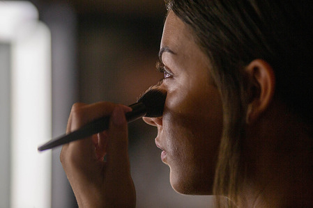 A woman applies eyeshadow to a model backstage before the runway during the inaugural Madrid es Moda 2025 fashion show in the Plaza de Oriente Gardens, in central Madrid. This is the tenth edition of Madrid es Moda and features more than 10 local designers showcasing flamenco fashion, accompanied by more than 30 models.