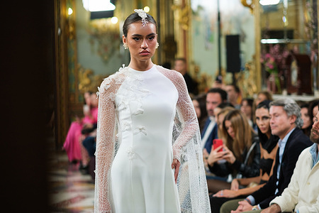 A model showcases creations by Lucia Cano during the Atelier Couture bridal catwalk within Madrid Fashion Week, at Santa Isabel Palace in Madrid.