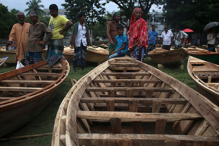 Buyers admire boats at the boat market, in Manukganj's Ghior Upazila
Due to the flow of Padma, Jamuna, Dhaleswari, Ichhamati, and Kaliganga through the district, lowlands go under water during monsoon leaving no option for the residents but to buy a boat. Residents of these areas are using boats for decades, according to locals.