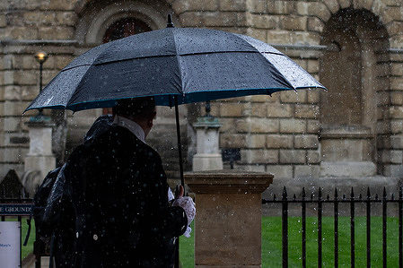 A couple takes shelter under an umbrella during the demonstration. Hundreds of people took to the streets to celebrate the 22nd annual Oxford Pride. Despite intermittent showers, people of all ages marched through the city center to celebrate the LGBTQ+ community in Oxfordshire and to protest against discrimination and violence faced by LGBTQ+ individuals and to call for equal rights and recognition.