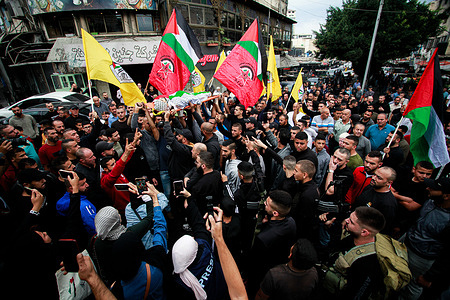 (EDITORS NOTE: Image depicts death)
Mourners carry the body of Amer Arqawi during his funeral, a day after he was reportedly killed during an Israeli raid in the West Bank city of Jenin. According to the Palestinian Health Ministry, one Palestinian was killed and another three were injured during clashes with Israeli troops. Since 07 October 2023, 185 Palestinians have been killed, while over 2,000 have sustained injuries in the West Bank.