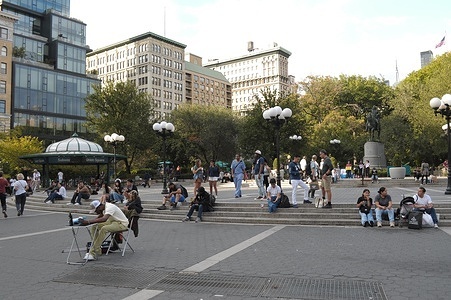People sit in Union Square in Manhattan, New York City.