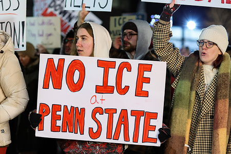 Demonstrators hold placards as they march on College Avenue during a protest against U.S. Immigration and Customs Enforcement (ICE). The protest was organized by the Student Committee for Defense and Solidarity in response to an ICE agent killing Renee Nicole Good in Minneapolis.