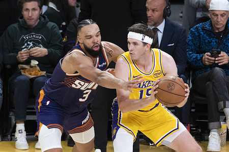 Los Angeles Lakers’ Austin Reaves (15) is defended by Phoenix Suns’ Dillon Brooks (3) during an NBA basketball game, in Los Angeles Monday Dec. 1, 2025.