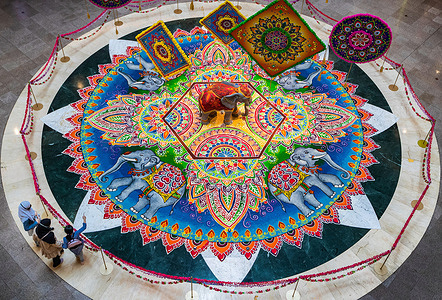Shoppers are seen looking at the Kolam display, a form of Indian traditional decorative art drawn by using rice flour and white stone powder with natural colour powders at a shopping mall for the upcoming Deepavali celebration in Kuala Lumpur.