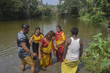 A devotee goes into a trance right after the ritual bath.
Tamil community of Bandel observe 'Vel Vel' festival to worship god "Shitala maa".In this festival many devotees pierce their skin, tongue, or cheeks with vel skewers as they undertake a procession towards temple.
