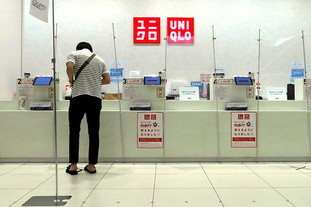 Fast Retailing's fashion chain Uniqlo employee help customer from behind a plastic curtain as a preventive measure during the Coronavirus (COVID-19) crisis.
Japan has so far confirmed 17,018 coronavirus cases, 903 deaths and 14,867 recovered.