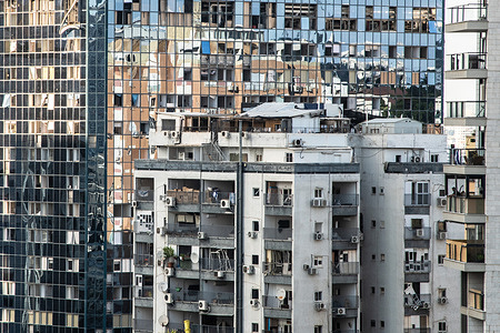 A month after an Iranian ballistic missile barrage, shattered windows and partially damaged buildings remain visible in Ramat Gan.