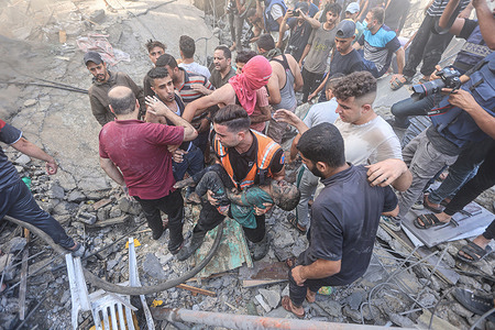 (EDITORS NOTE: Image depicts death)
Palestinians recover a body of a child from the rubble of a building following the Israeli bombardment in Deir Balah amid ongoing battles between Israel and the Palestinian group Hamas. Thousands of civilians, both Palestinians and Israelis, have died since October 7, 2023, after Palestinian Hamas militants based in the Gaza Strip entered southern Israel in an unprecedented attack triggering a war declared by Israel on Hamas with retaliatory bombings on Gaza.