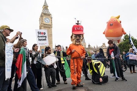 A protester is seen wearing a big Donald Trump's mask during the demonstration. Following Donald Trump’s second state visit to the United Kingdom, thousands of protesters, led by Stop Trump Coalition, have set up a protest in Central London against the event, they have condemned Trump’s support for the far-right activism.