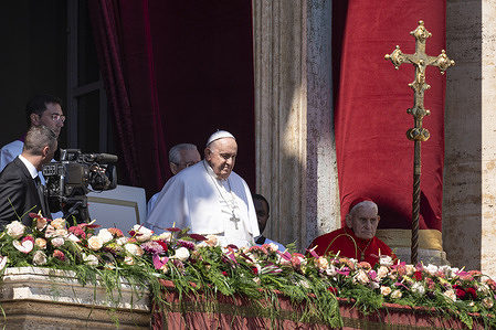 Pope Francis overlooks at the central balcony of St. Peter's Basilica. Christians around the world are marking the Holy Week, commemorating the crucifixion of Jesus Christ, leading up to his resurrection on Easter.