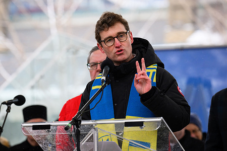Member of Parliament Yvan Baker gestures while addressing a crowd at Nathan Phillips Square during the "Stand with Ukraine" rally. Baker reaffirmed the Canadian government's commitment to long-term military and financial aid on the fourth anniversary of the full-scale Russian invasion. Thousands gathered in downtown Toronto to commemorate the fourth anniversary of the full-scale Russian invasion of Ukraine and show solidarity with those on the front lines.