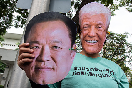A Thai activist wearing a mask of US President Donald Trump holds a mask of Thai Prime Minister Anutin Charnvirakul during a protest against the rare earth deal between Thailand and USA outside the Embassy of the United states in Bangkok. Thai activists gathered outside the Embassy of the United States in Bangkok to protest against the rare earth minerals deal that signed by the Thailand government and the United States, expressing a concerns that it could cause pollution and harm local communities, property, and ecosystems.