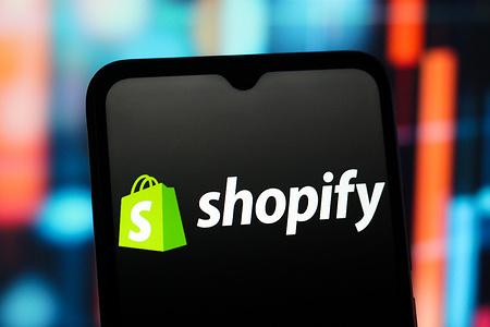 In this photo illustration, the Shopify logo is seen displayed on a smartphone screen.