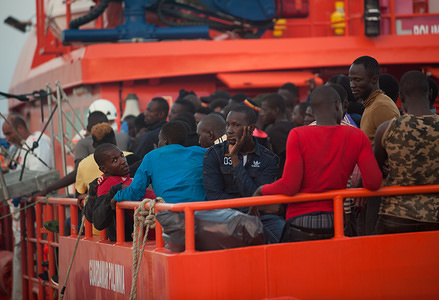 Migrants, who were rescued from a dinghy in the Mediterranean Sea, stand on a rescue boat after their arrival at Port of Malaga. Members of the Spanish Maritime Safety rescued a total of 180 migrants aboard three dinghies from Alboran Sea and brought at Malaga harbour, where they were assisted by the Spanish Red Cross.