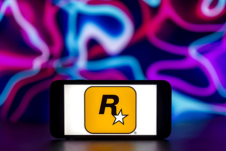 In this photo illustration, the Rockstar games logo is seen displayed on a mobile phone screen.