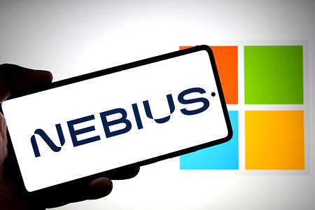 In this photo illustration, a Nebius logo is seen displayed on a smartphone with a Microsoft logo in the background.