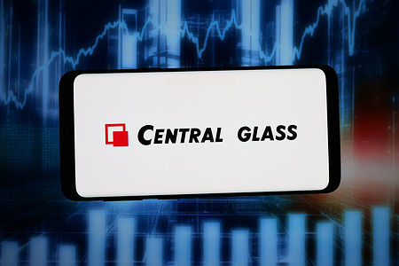 In this photo illustration, the logo of Japanese company Central Glass Co. Ltd. is seen displayed on a smartphone in front of an abstract background on a computer screen.
