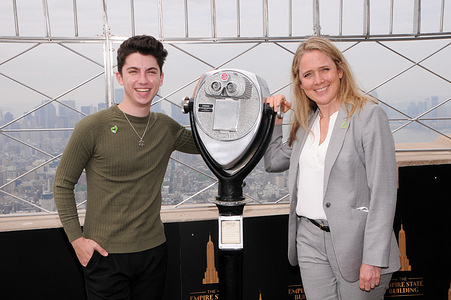 Eitan Bernath and Jen McLean, COO of City Harvest, visit the Empire State Building to celebrate City Havest's 'Share Lunch Fight Hunger' campaign in New York City.