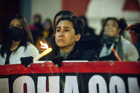 A protester holds a candle during an anti-ICE protest in downtown Los Angeles, where protesters gathered in response to the killing of Renee Nicole Good in Minnesota.
