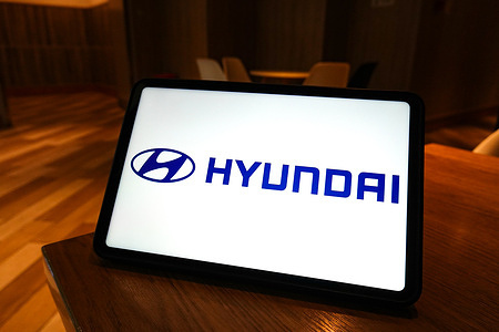 In this photo illustration, the Hyundai logo is seen displayed on the screen of a smart tablet.