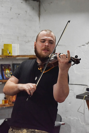 Ukrainian army soldier seen performing during the volunteer concert for rescuers and local residents in a shelter in Huliaipole. Huliaipole is situated close to the frontline in the Zaporizhzhia region where Ukraine's counter-offensive against Russian forces took place. The town has suffered daily drone and artillery attacks from Russian forces.
